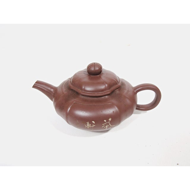 A beautifully understated vintage Chinese Yixing-style teapot, distinguished by its softly lobed form, rich reddish-brown...