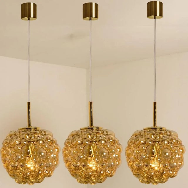 1 of the 3 beautiful pendant with bubbled glass by Helena Tynell, manufactured around the 1970s. High-end hand blown amber...