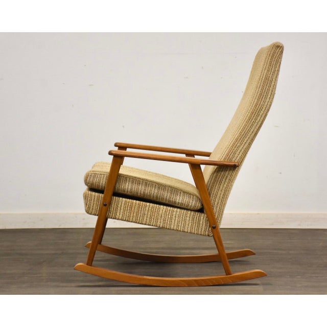 A mid century modern oak frame rocking chair. Seat height is 17.5”. 25.5” wide. 35.5” deep. 41” tall.