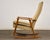 A mid century modern oak frame rocking chair. Seat height is 17.5”. 25.5” wide. 35.5” deep. 41” tall.