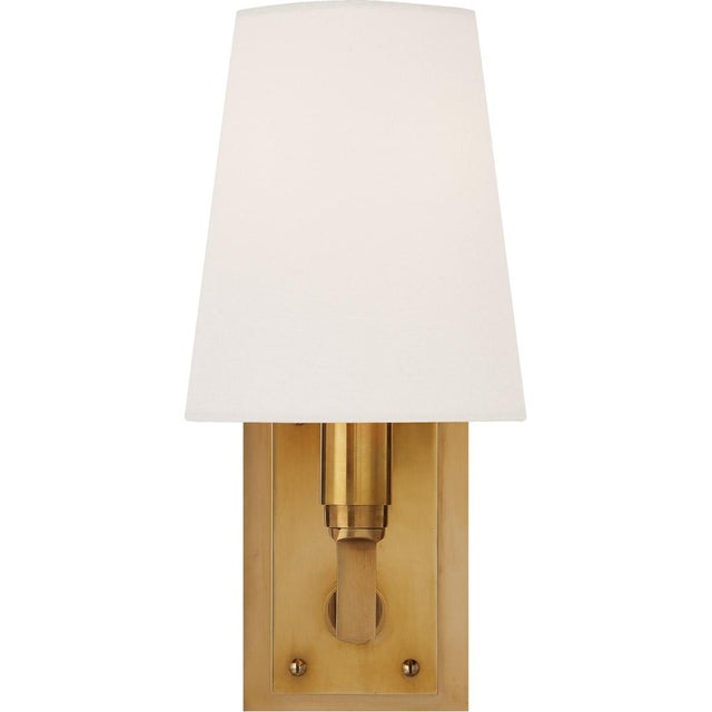 Watson Small Sconce in Hand-Rubbed Antique Brass with Linen Shade Designer: Thomas O'Brien Height: 10.75" Extension: 6.25"...