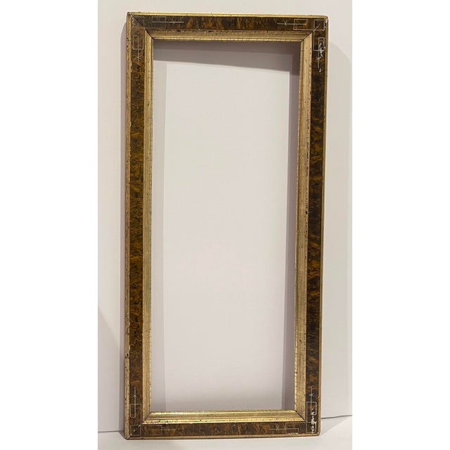 An American Eastlake or Renaissance Revival painting frame, faux burl center panel with gilded edges and geometrically...