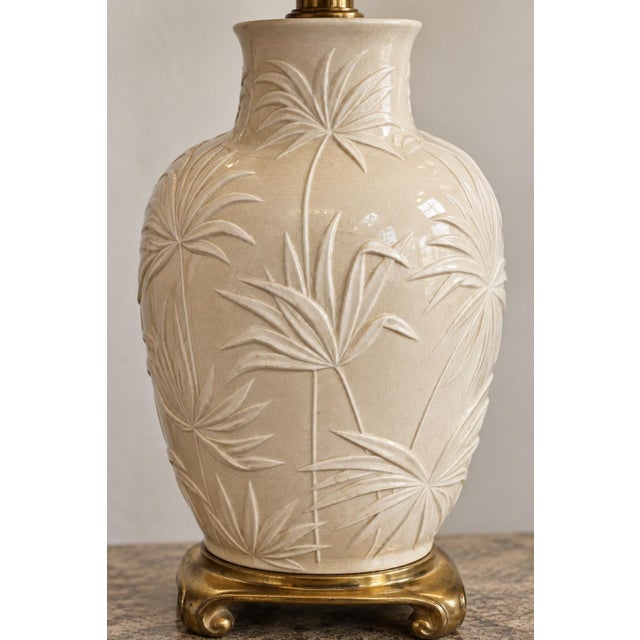 A grand vintage ceramic urn lamp reimagined in a richly layered Coastal Regency style. Its substantial warm-ivory ceramic...