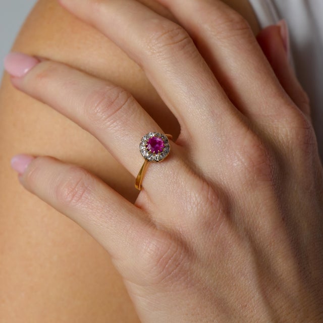 This exquisite Victorian cluster ring is a rare and deeply romantic treasure from the turn of the 20th century, centered...