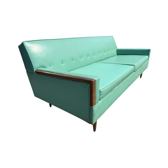 Add a vibrant pop of color to your space with this stunning 1960s Mid-Century Modern turquoise loveseat. Featuring its...