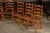 French Provincial Set of Seven Mid-Century French Country Ladder Back Chairs With Rush Seats For Sale - Image 3 of 9