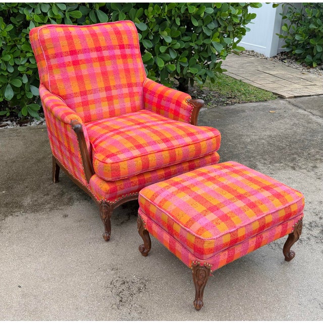 Antique carved wood bergère-style lounge chair with matching ottoman, featuring exceptionally vibrant plaid upholstery in...