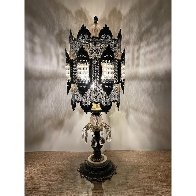 Striking vintage 1972 Hollywood Regency table lamp with an ornate pierced metal shade, faceted crystal-style accents,...