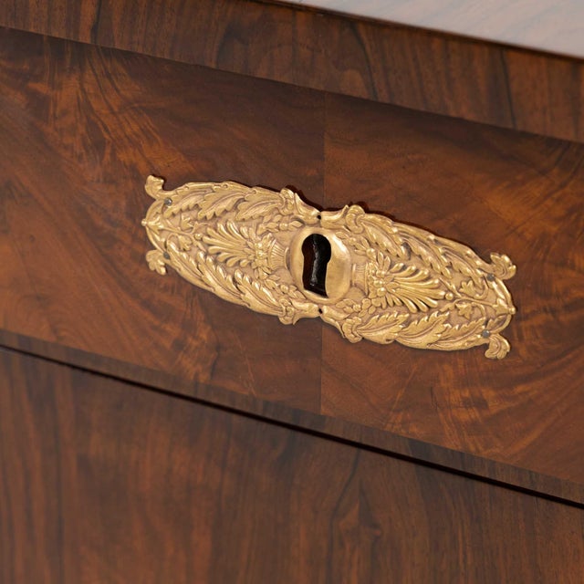 This impressive pair features three spacious drawers and stands on tall feet with gilded brass profiles. Each chest is...