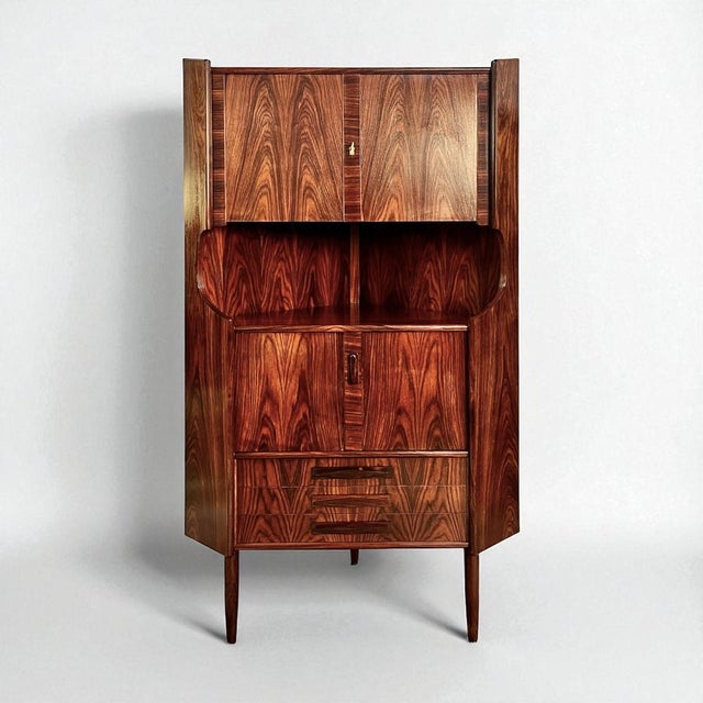 This exquisite Danish rosewood corner cabinet, originating from the 1960s-1970s, showcases remarkable artisanship through...