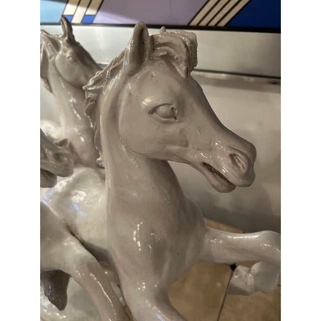Large dramatic glazed terracotta sculpture of galloping horses, having glossy cream color. The details and powerful...