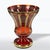 Luxurious ruby glass vase with an elegant design, adorned with intricate details that emphasize its exceptional character....