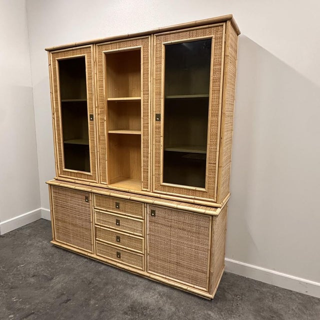 A stunning 1970s Italian rattan and bamboo display cabinet by Dal Vera, renowned for their refined craftsmanship and...