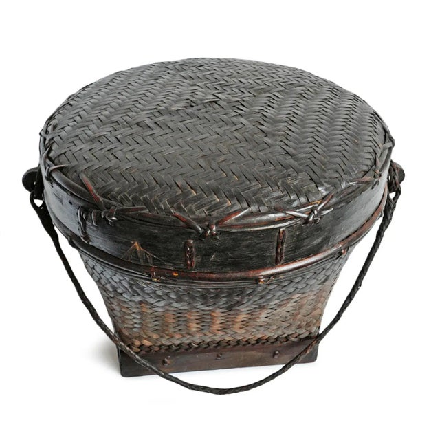 Vintage Akha Thai hand woven basket with lid. Rich dark finish with signs of age and use. Circa mid 20th century.