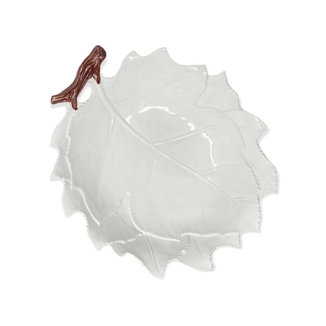 A wide, leaf-shaped serving bowl, hand-painted in Italy. As hand-painted work, expect slight variation in the glaze and...