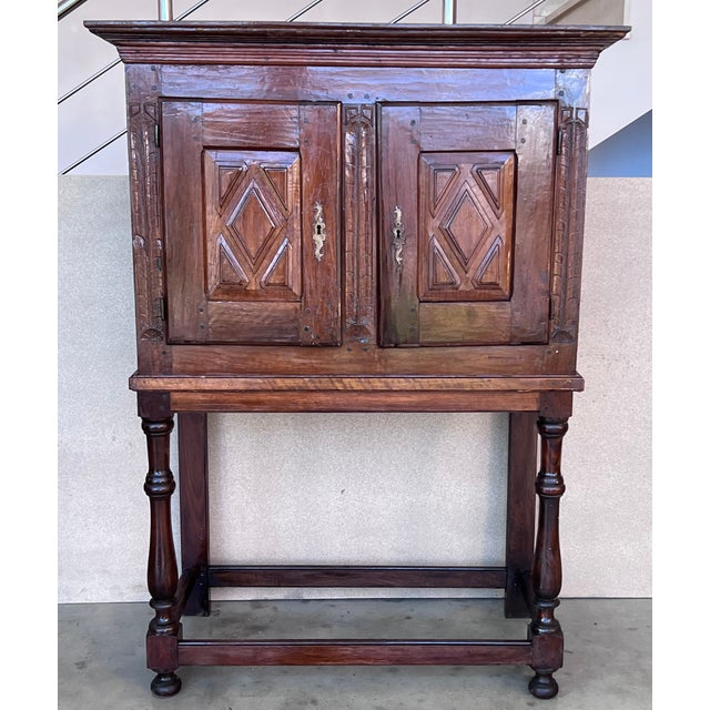 19th Catalan Spanish cabinet on stand in carved walnut with two doors in the cabinet. Details Dimensions Height: 60.79 in...