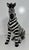 Elegant seated zebra sculpture, produced in Bassano del Grappa, Italy. Hand-decorated in glazed ceramic, it features...