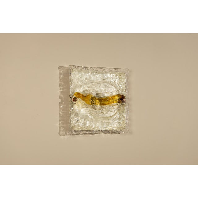 A composition of textured glass and warm light, the “Quilt” wall lamp by Toni Zuccheri for Venini captures the...