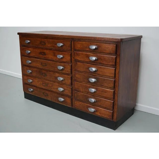 This fabric store cabinet was made around the 1940/50s in France from oak. It features 6 large drawers and 7 smaller ones...