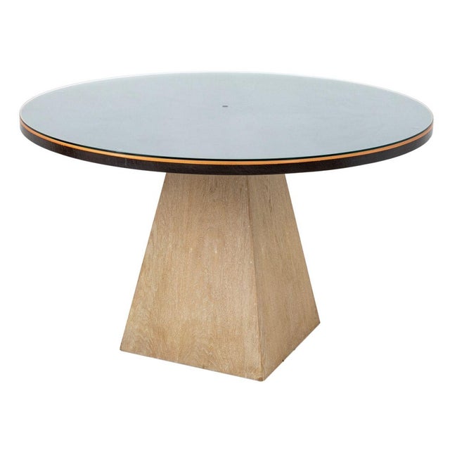 Modern Circular Glass Top Dining Table, on a trapezoidal oak base. 31" H x 49.25" Diameter. Provenance: From a Palm Beach...