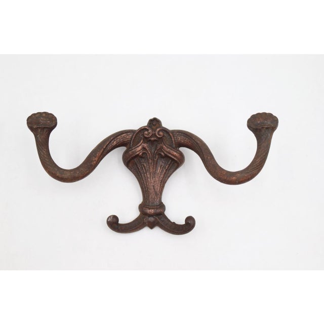 Antique Victorian style hall tree hooks made of cast iron with a mixed copper and black finish. The original mounting...