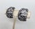 1970s silvertone floral half hoop clip back earrings. Marked "Napier." Measure: 1 1/16 inches long by 11/16 inches wide....
