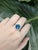 Crafted in 14k gold (3.61g), this striking ring features a deep 4.25-carat round London Blue Topaz from Brazil, measuring...
