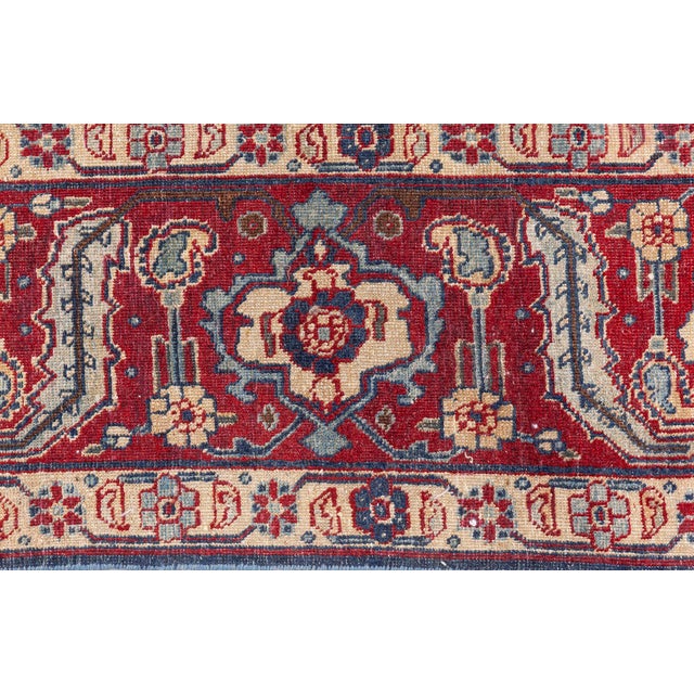 An early 20th century Persian Tabriz rug, the black field with a bold trellis design of stylized palmettes and floral...