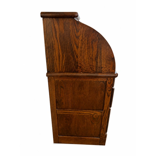 Classic vintage roll-top desk crafted in richly grained oak with a warm medium-brown finish. Featuring the iconic curved...