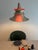 When lit, a warm red glow emanates from within the nested inner shades. Attributed to Bent Nordsted, the lamp's...