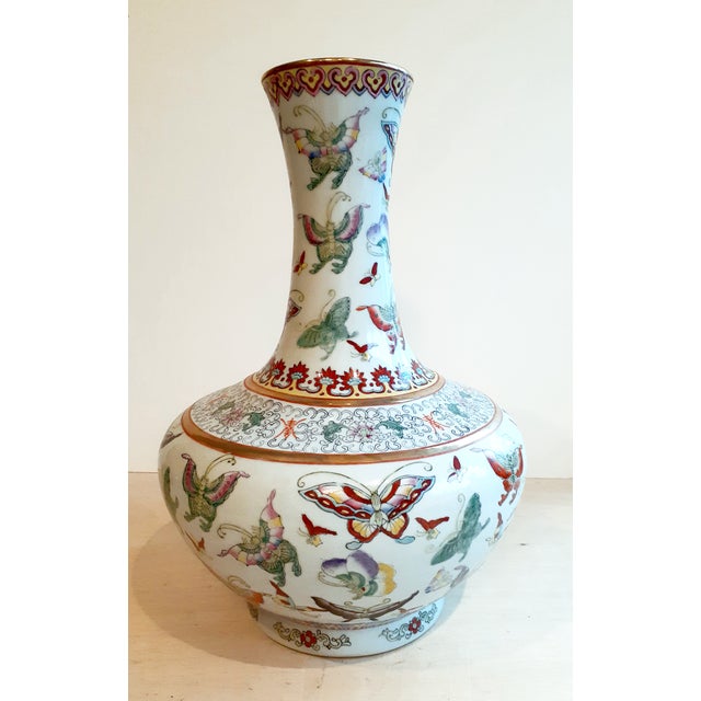 Chinese Porcelain butterfly changjingping, a finely formed, long necked vase with a gold glazed lip, and a white glazed...