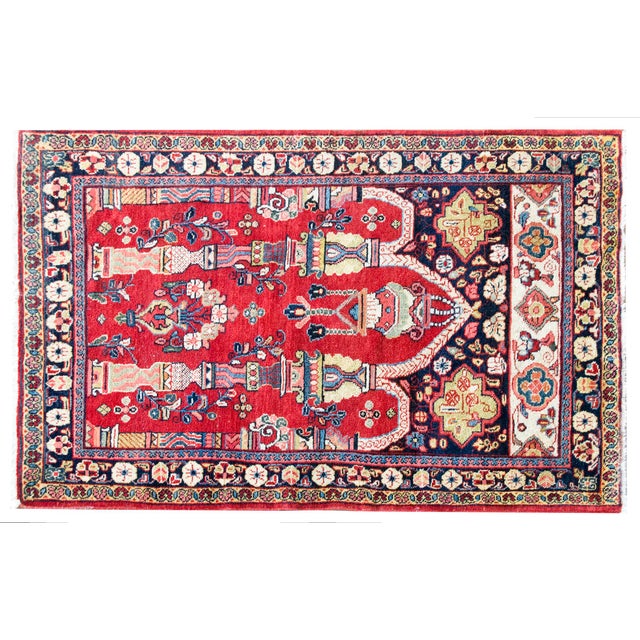 This vintage Persian Meshkabad rug features a striking architectural design with prominent pillars and arches set against...