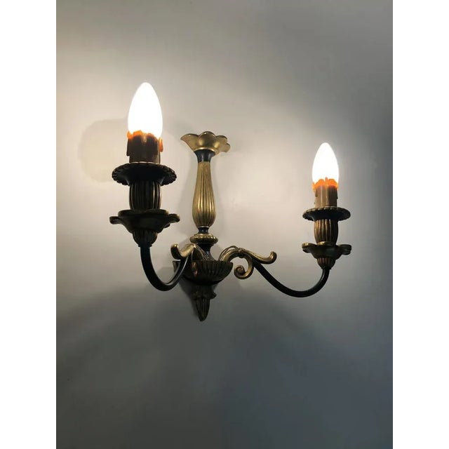 Pair of Empire-style double-light bronze wall sconces. Early 20th century Charming vintage pair of Empire-style wall...
