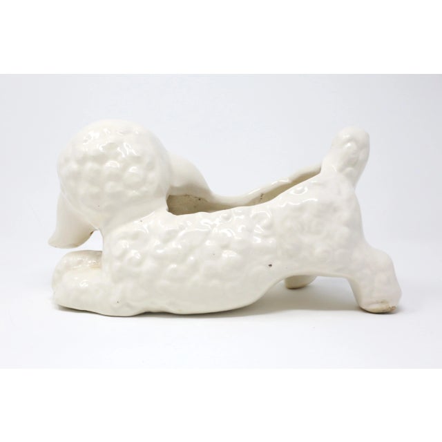 A vintage ceramic planter in the form of a playful lamb with a blue bowtie. Good vintage condition; minor wear consistent...