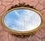 An ornate mirror reflecting the Louis XVI style, popular in France during the 18th century and continued to be reproduced...