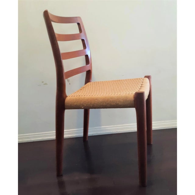 This beautiful teak dining chair was designed by Niels Otto Møller for J.L. Møllers Møbelfabrik . Model no. 85, crafted in...