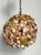 Transport your interior to a seaside sanctuary with this captivating vintage shell-encrusted sphere pendant light. This...