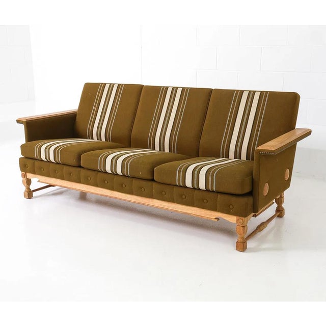 A hip and stylish retro modern, circa 1960's/70's Danish mid century sofa. The sofa is constructed on a solid figured wood...