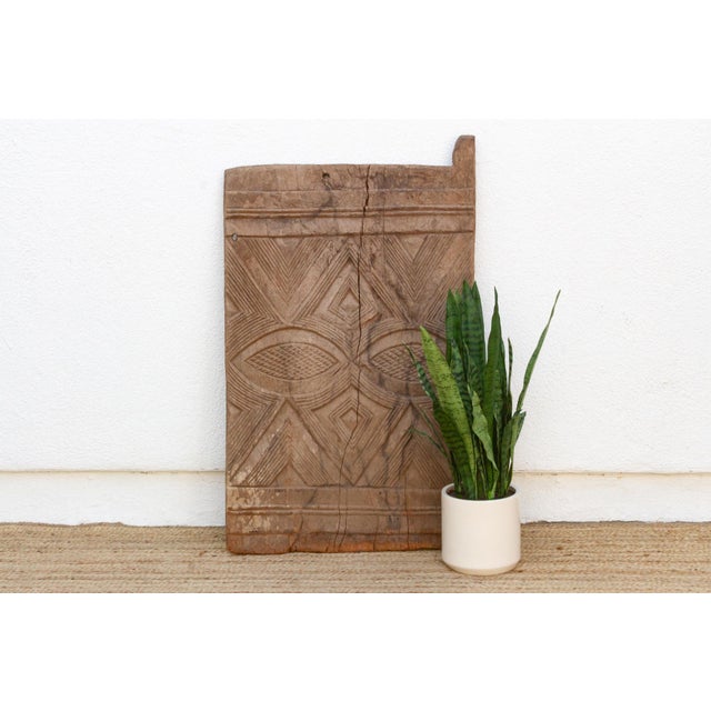 This 44-inch carved panel is Igbo work from southeastern Nigeria's Awka carving tradition, hand-hewn from a single two-...