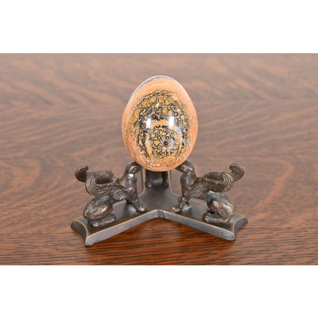 A gorgeous antique Art Deco leopard skin jasper egg on bronze base with griffins USA, Circa 1930s Measures: 5.5"W x 5.5"D...