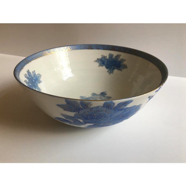 A pretty Imari style bowl with powder blue peonies and phoenix decoration. Outlines and details are in 22K gold. There is...