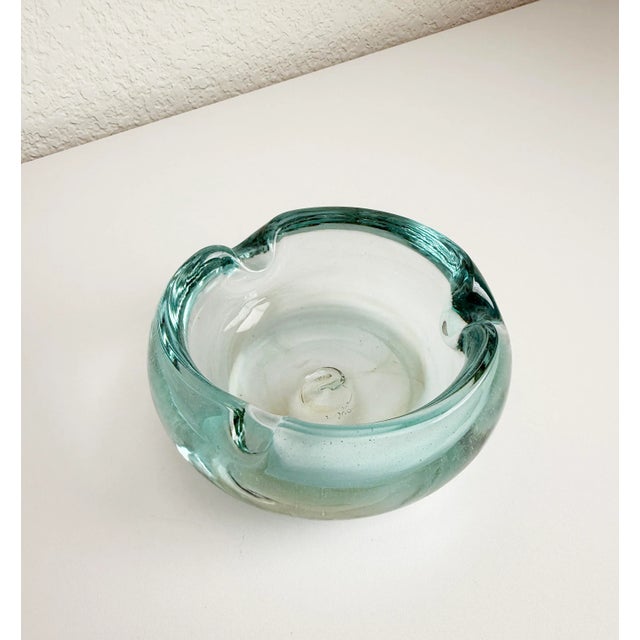 1950's cigar ashtray made of hand-blown glass with substantial weight and presence. Features a pale blue coloring, light...