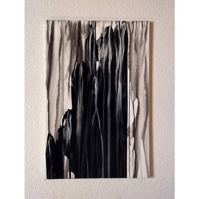 This ink on canvas artwork presents a dramatic interplay of deep blacks and soft grays, evoking the tumultuous energy of...