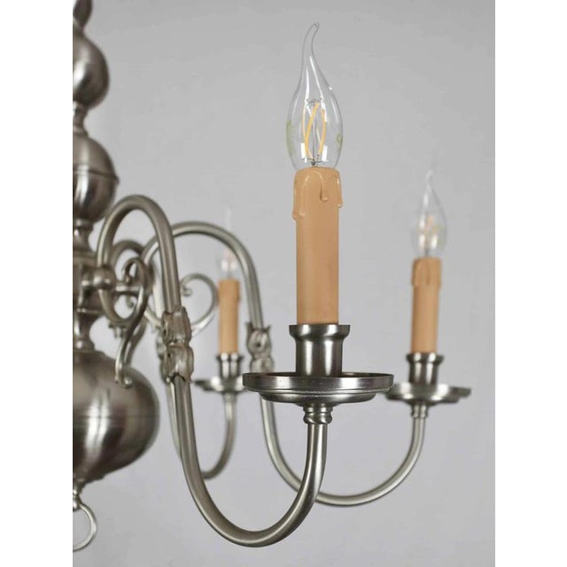 White brass chandelier after complete restoration of the electrical installation - complete new cables, sockets and...