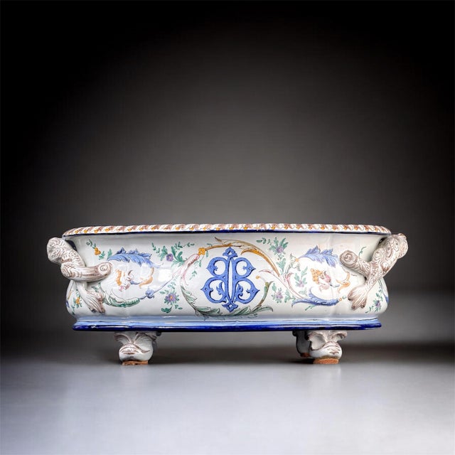 Elegant French faience jardiniere dating to the late 19th century, beautifully hand-painted with floral and foliate...