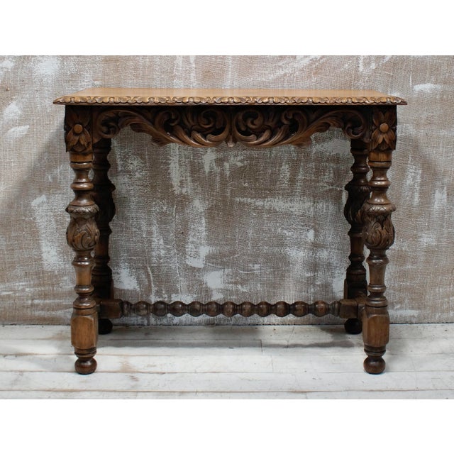 A Superb Oak Hall Table. Made from English Oak, with beautiful hand carving to the top, with a floral design continuing...