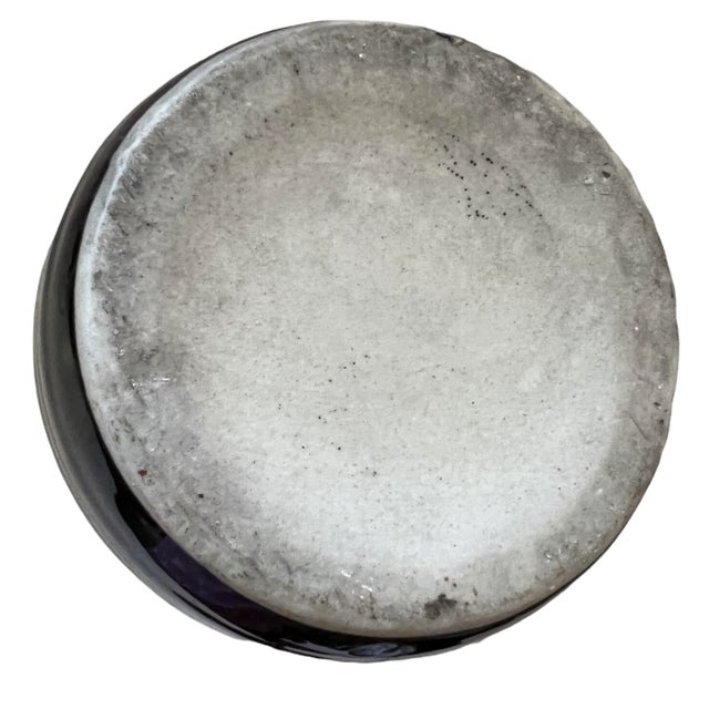 Mid-century Japanese ceramic vase, cylinder-shaped with thick walls, glossy black glaze, almost smooth finish with minimal...