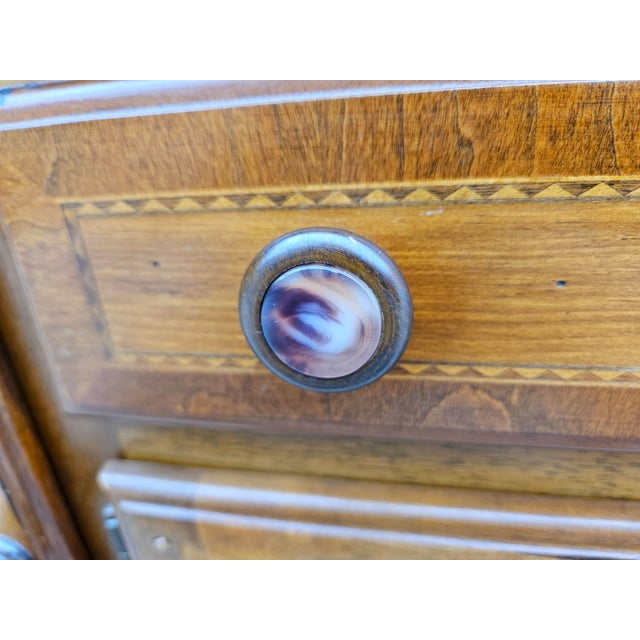 This mahogany sideboard with inlaid accents, a banded top and brass rail, is part of the Alexander Julian Colours...