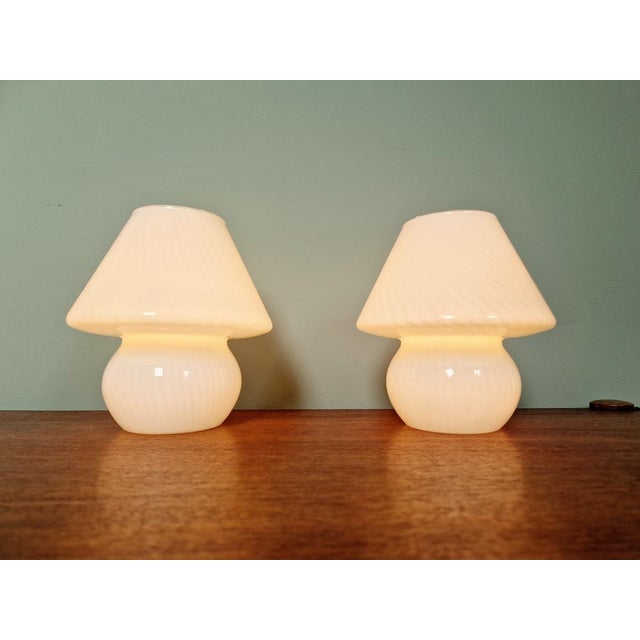 Pair of Murano glass mushroom lamps, 1970s. These transparent white glass lamps have pretty swirling patterns. They are in...