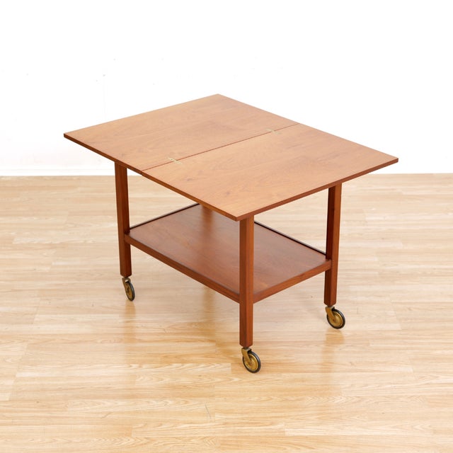 Mid-century folding bar cart made in England during the 1950s. A striking little cart with a folding top that doubles as a...